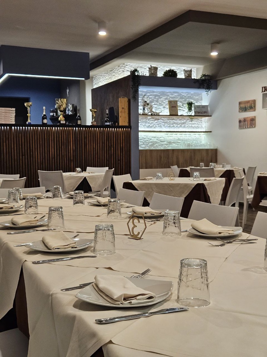 Sala di Unni Manci apparecchiata, parete blu e boiserie in legno